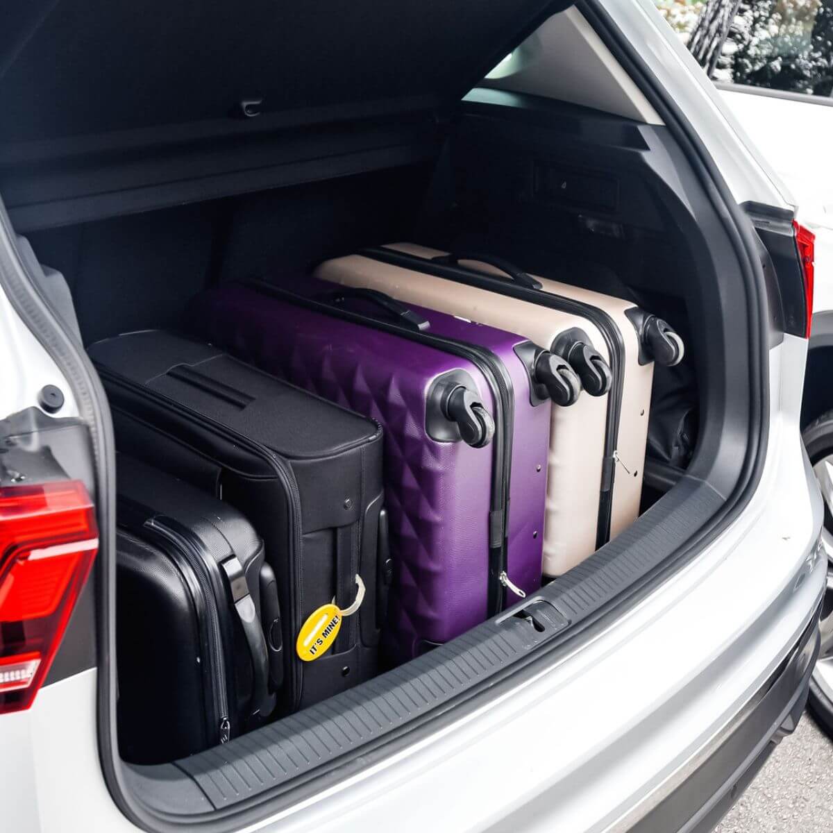 open car boot with suitcases inside