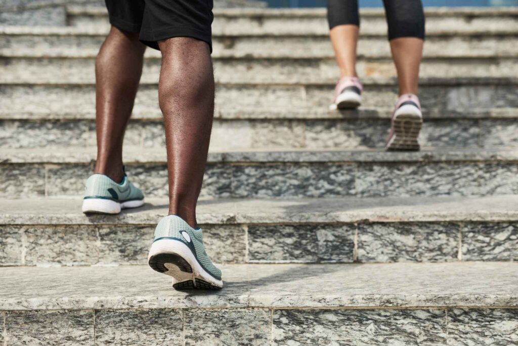 Image shows two people running up steps